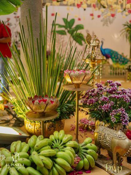 More details from our traditional decor. We use a lot of brass elements, like these lotus-shaped urlis and lamps, combined with fresh flowers and banana stalks to create a rich, festive look.