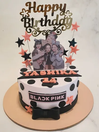 A cake for a Blink! This Blackpink-themed cake features a photo of the group, their logo, and a pink and black color scheme perfect for a K-Pop fan.