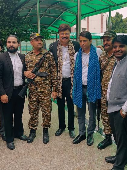 Posing with colleagues and security personnel during Independence Day festivities.