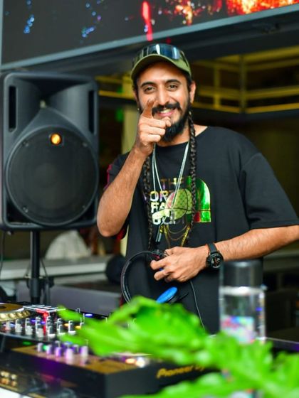 Pointing at the camera, inviting you to join the party. It's all about sharing the good vibes and love for music.