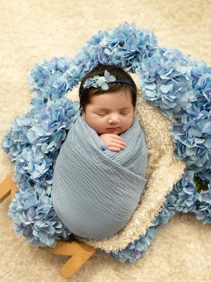 This little one takes my heart away. A classic swaddled pose surrounded by a bed of blue hydrangeas creates a portrait that is both simple and breathtakingly beautiful.