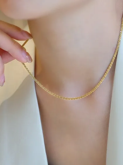 This delicate, shimmering chain is perfect for a subtle touch of elegance. It's designed to catch the light beautifully and can be worn alone or layered with other necklaces.