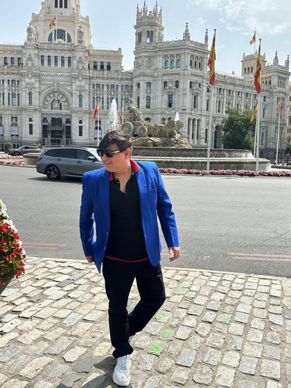 A candid shot while walking through Plaza de Cibeles, showcasing a relaxed yet put-together travel look.