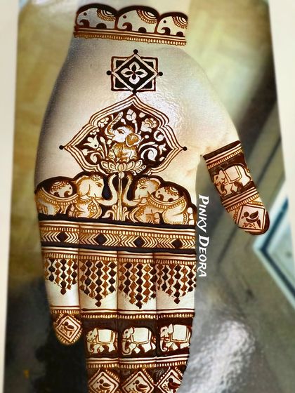 A close-up of a traditional design featuring Lord Ganesha and majestic elephants. This style is perfect for brides who want a rich, heavy look filled with auspicious symbols.