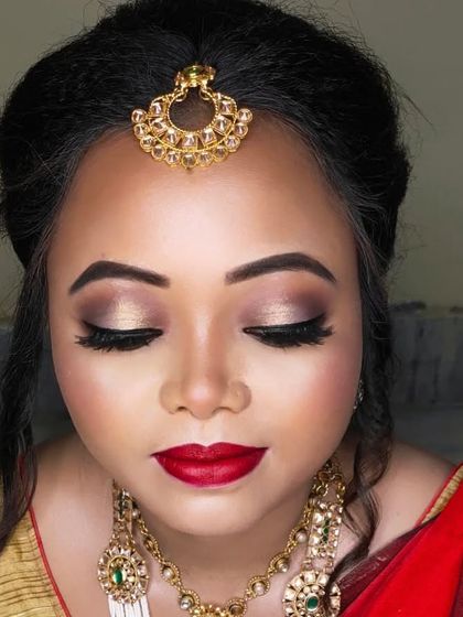 A detailed shot of the eye makeup, with soft gold and brown tones and dramatic lashes.