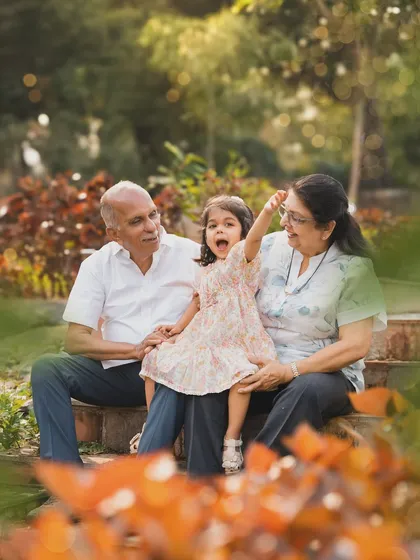 A little girl shares an animated story with her grandparents during an outdoor session. Capturing the bond across generations is one of my greatest joys.