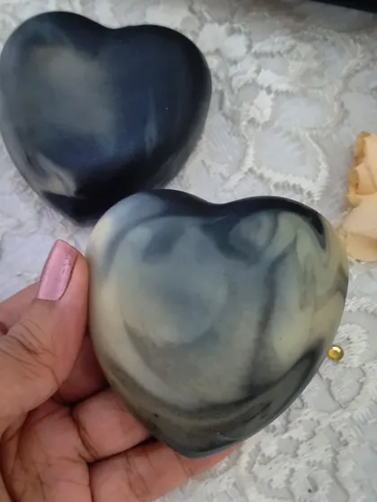 Holding a marbled, heart-shaped Lush Lavender soap. The swirls of indigo and white create a beautiful, calming effect.