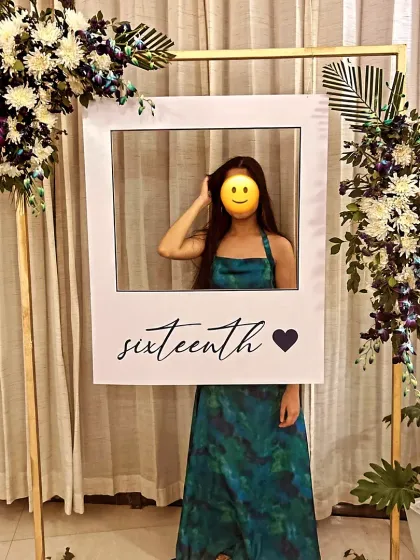 For a sweet sixteen, I created this chic and modern selfie booth. The simple gold frame was adorned with real flowers, and the custom polaroid-style cutout was a fun prop for the birthday girl and her friends.