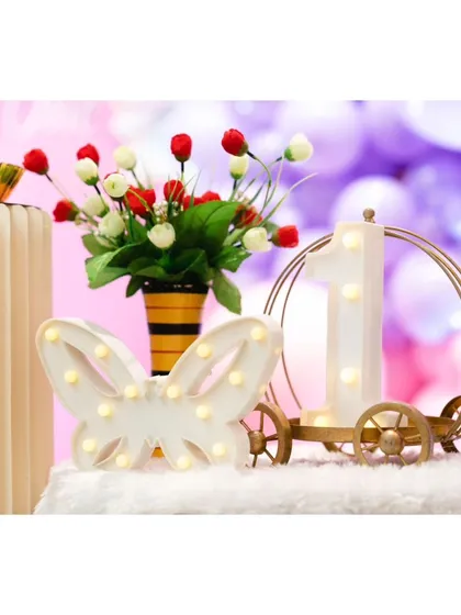 The little detail's make a party truly special. For this butterfly-themed first birthday, we included custom marquee light's like this butterfly and a number '1' carriage, adding a warm and personalized glow to the cake table.