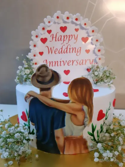 A romantic anniversary cake featuring a custom photo and delicate baby's breath flowers. It’s a beautiful way to tell your story.