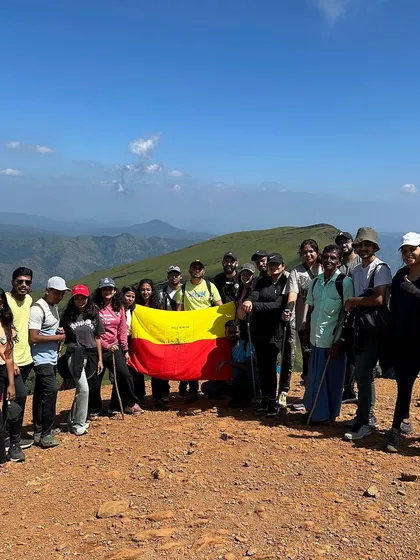Our group proudly holding the Karnataka flag at the summit of Netravathi Peak.