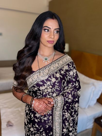 This shot captures the complete look, with the intricate embroidery of the saree complemented by the polished and elegant makeup.
