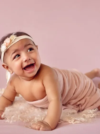Tummy time pro! This 4-month-old is showing off her strength and adorable smile during her milestone photoshoot.