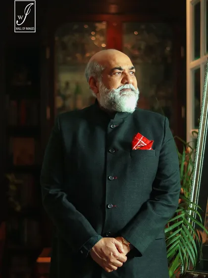A corporate headshot doesn't have to be boring. For this portrait of a distinguished professional, we created a sophisticated atmosphere using a classic setting and careful lighting to convey authority and experience.