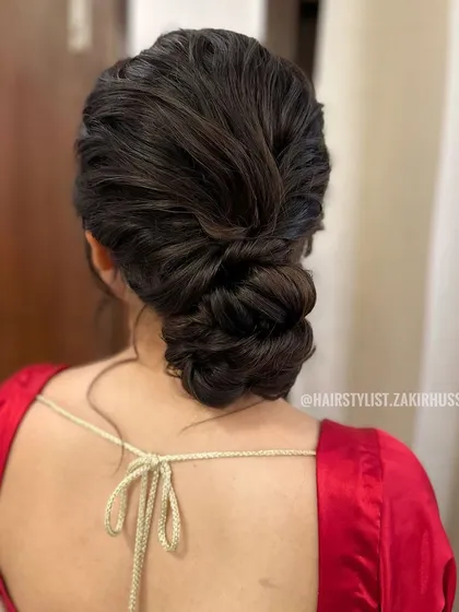 A slightly different angle of the textured messy bun, showing the clean lines of the braid contrasting with the softer bun.