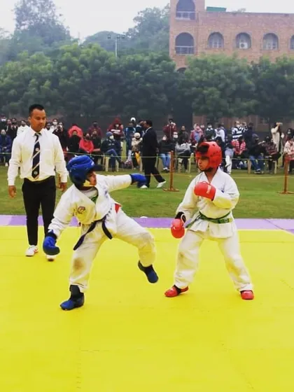 Two of my young tigers engaged in a competitive sparring match. We emphasize proper technique, control, and strategy from a young age, building a strong foundation for future championships.