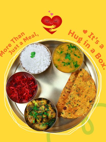 More than just a meal, it's a hug in a box. This colorful veg thali is designed to bring you comfort and joy.