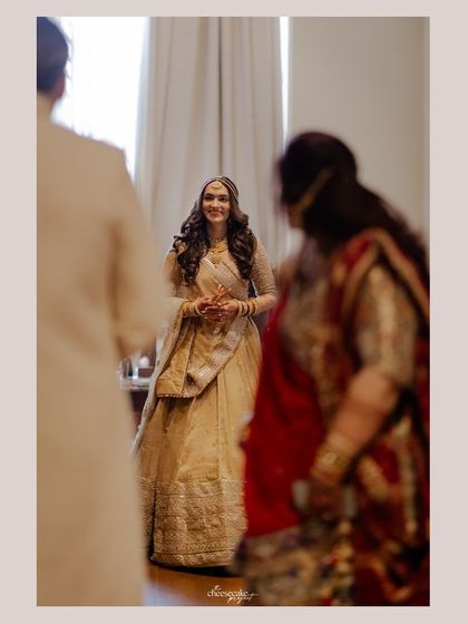 The bride's first look for her parents. Their expressions are a mix of awe and pride.