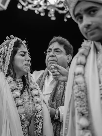 Sugam is overcome with emotion during a ritual in her wedding ceremony. These are the raw, unfiltered feelings that we are privileged to witness, capturing the profound emotional weight of the day.