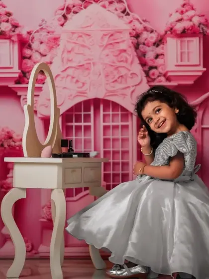 A glamorous pose in a beautiful silver gown. The detailed pink castle backdrop makes every child feel like royalty.