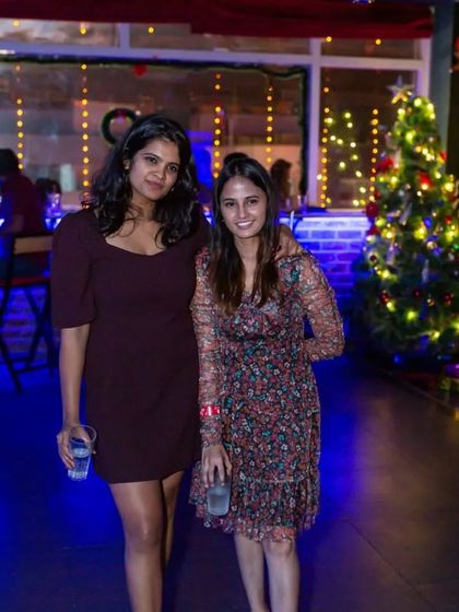 Two friends enjoying the Christmas decorations and festive vibe.