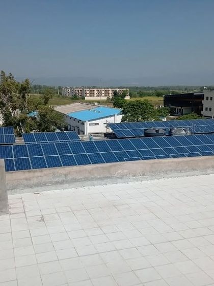 This view shows the solar panels against the backdrop of the surrounding area, illustrating how rooftop solar can be integrated into commercial and industrial zones without requiring additional land.