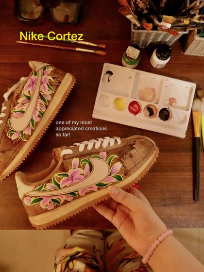Another look at the floral world map design on a pair of Nike Cortez. The coffee-dyed surface provides the perfect aged look for the map, while the bright pink lilies create a beautiful contrast.