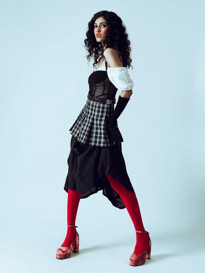 A side profile of the doll-like character, showcasing the complete silhouette against a clean background. This is ideal for a designer lookbook.