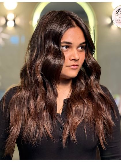 This rich brown color with soft waves is a perfect example of hair that is dipped in magic and confidence.