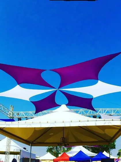 This is how I transform an open field into a vibrant festival space. This custom fabric canopy installation in Pune provided both shade and a stunning visual centerpiece for the Times Now food festival, using a dynamic pattern of purple and white sails against the sky.