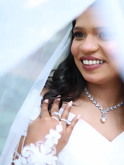 A dreamy close-up of the bride through her veil. The soft lighting enhances her glowing skin and the romantic feel of her makeup.