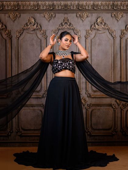 A full-length shot against one of our ornate, carved backdrops. Even with a modern black outfit, the traditional background adds a unique fusion element to the photograph.