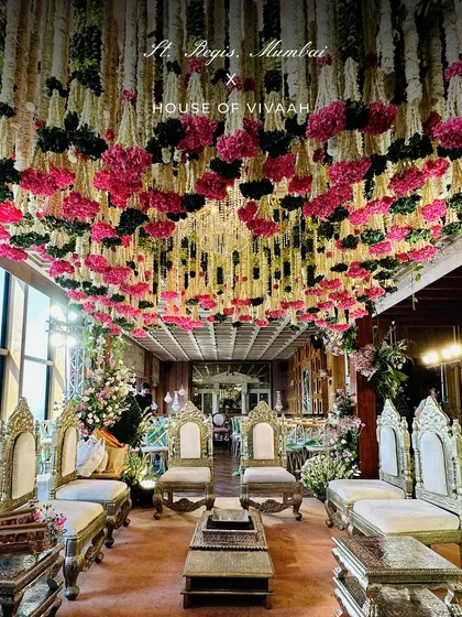 A wide shot of the mandap area, highlighting the stunning floral ceiling made of thousands of hand-strung flowers, creating an immersive and fragrant canopy.