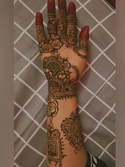 A beautiful semi-bridal or party design. The pattern combines traditional elements like the peacock with modern floral arrangements and spaced-out motifs on the arm.