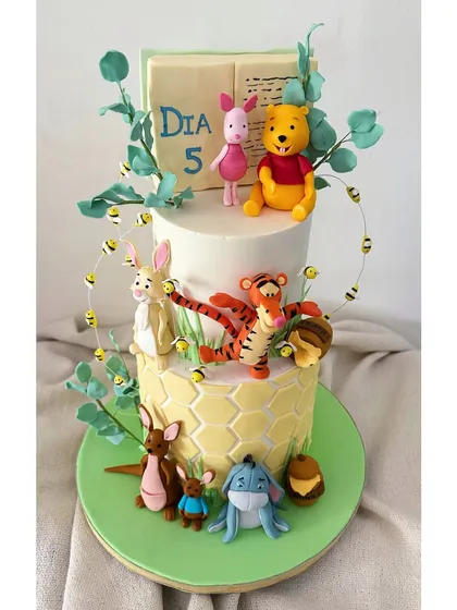 It was pure joy to recreate the world of Winnie the Pooh for a fifth birthday. Every character, from Pooh to Eeyore, was handcrafted from fondant, turning a delicious chocolate hazelnut cake into a storybook scene.