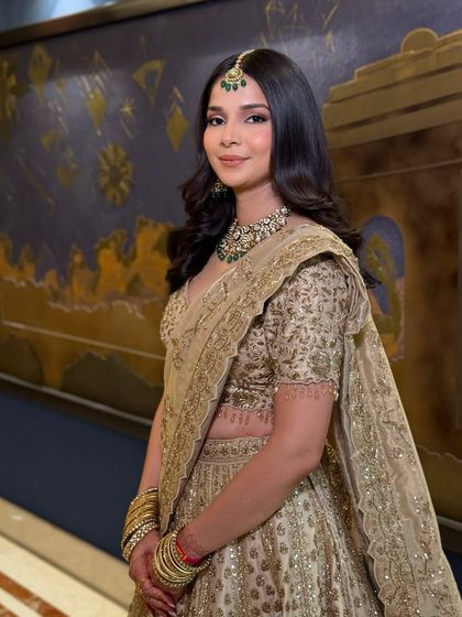 A wider shot of the soft and natural reception look. The makeup is minimal and fresh, allowing her natural beauty and elegant jewelry to be the main focus.