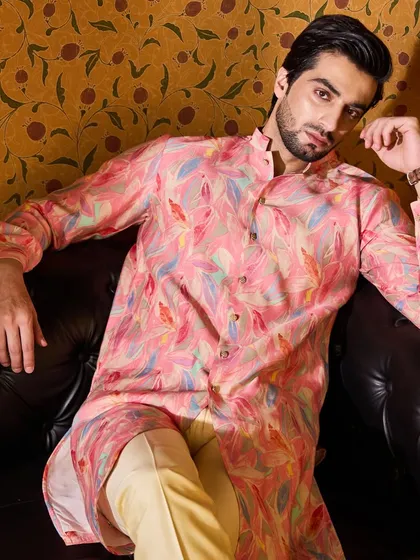For a more casual festive look, I designed this printed kurta with a vibrant pink leaf pattern. It's a modern and stylish piece for a relaxed celebration or puja.