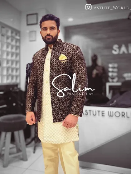 A client in a classic Indo-Western look, pairing a patterned jacket over a cream-colored kurta set. This is a timeless choice for a sangeet or mehndi ceremony.