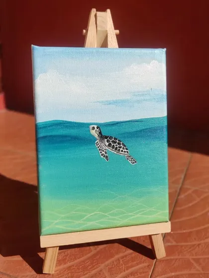 This little sea turtle was painted with acrylics on a mini canvas. I focused on capturing the clear, turquoise water and the detailed pattern of the turtle's shell. These small canvases are great for desks, shelves, or as a thoughtful gift.