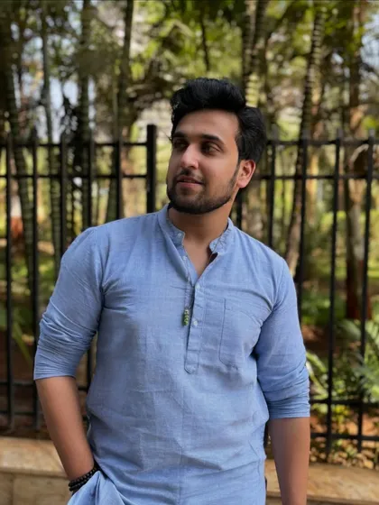 A simple and elegant portrait in a light blue cotton kurta. This demonstrates a more casual, everyday ethnic look suitable for a wide range of brands.