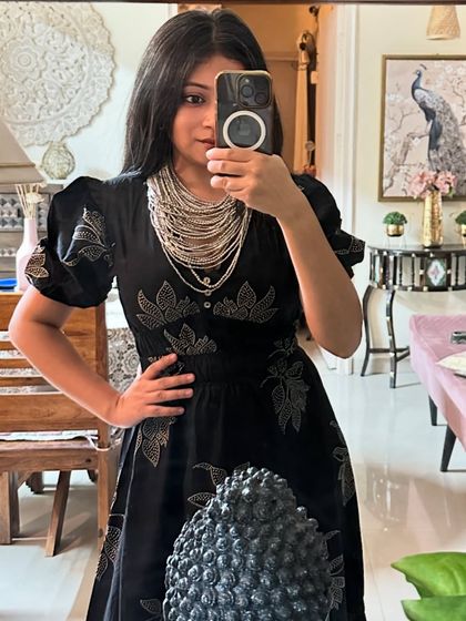 Another mirror selfie with the black dress, this time with a statement silver necklace. It shows how changing just one accessory can create a different mood.