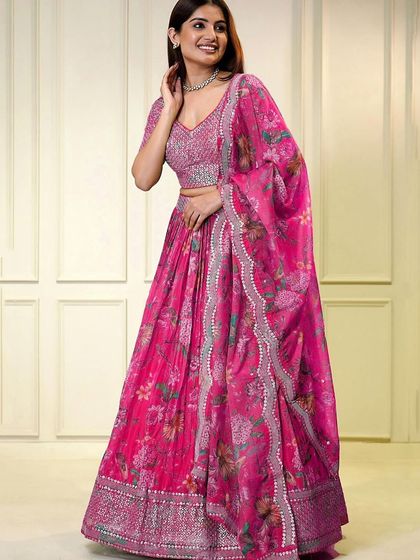 It's all in the details. This pink organza lehenga features a stunning sequined blouse with a stylish keyhole back, perfect for making an impression at an engagement or reception.