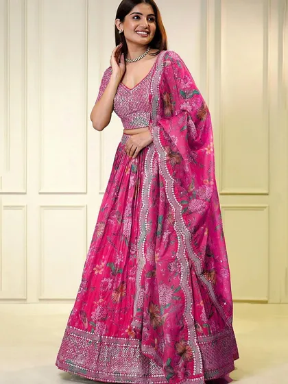 It's all in the details. This pink organza lehenga features a stunning sequined blouse with a stylish keyhole back, perfect for making an impression at an engagement or reception.