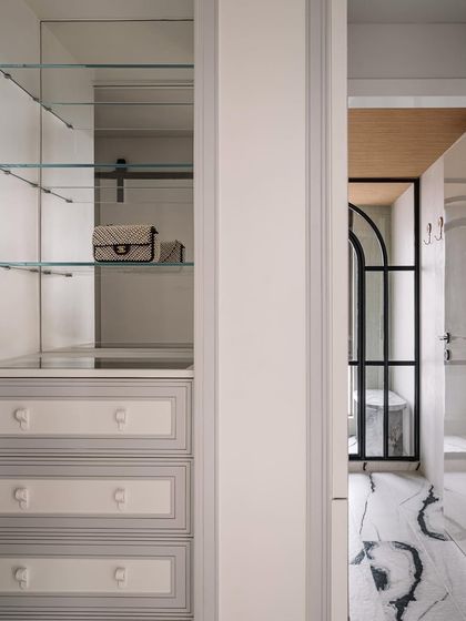 A glimpse into the master closet and bathroom, showing the seamless flow and the calm, organized design of the private spaces.