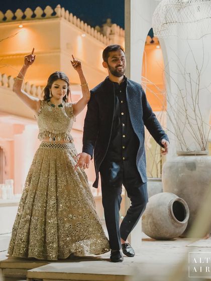 The couple making their entrance at the 'Muted Melodies' sangeet. The earthy, moonlit ambiance with its muted settings and modern arches created a magical world for them.