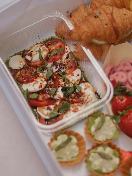A detailed shot of the caprese salad and asparagus tarts from our Valentine's grazing box.