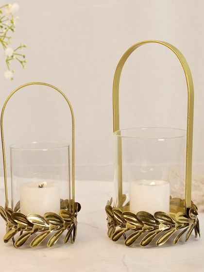 A pair of golden metal and glass candle lanterns. The clean, bright lighting showcases their design and is ideal for e-commerce listings on platforms like Amazon.