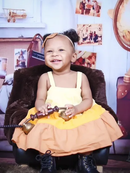 This little girl is all smiles while playing with an old-fashioned telephone prop.