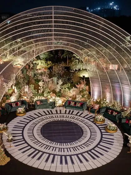 I designed this unique musical-themed reception around a grand piano-key dance floor, enclosed within a dramatic arched structure. It was a night where every detail was in perfect harmony, creating a visual and sensory masterpiece.