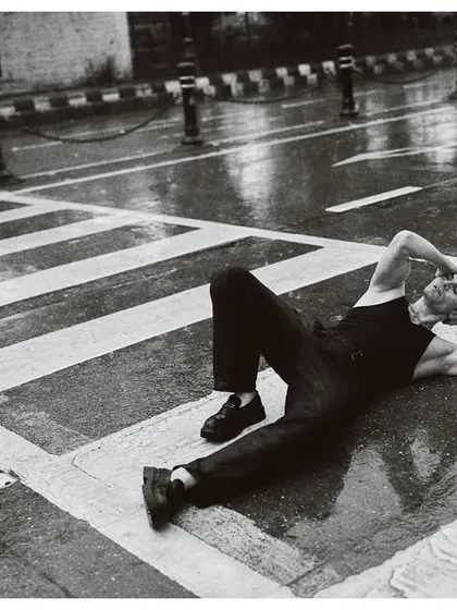 Lying on an empty, rain-slicked street in Colaba, Mumbai. This shot was about capturing a moment of peace in a city that never sleeps. The black and white treatment emphasizes the reflections and the texture of the wet asphalt.